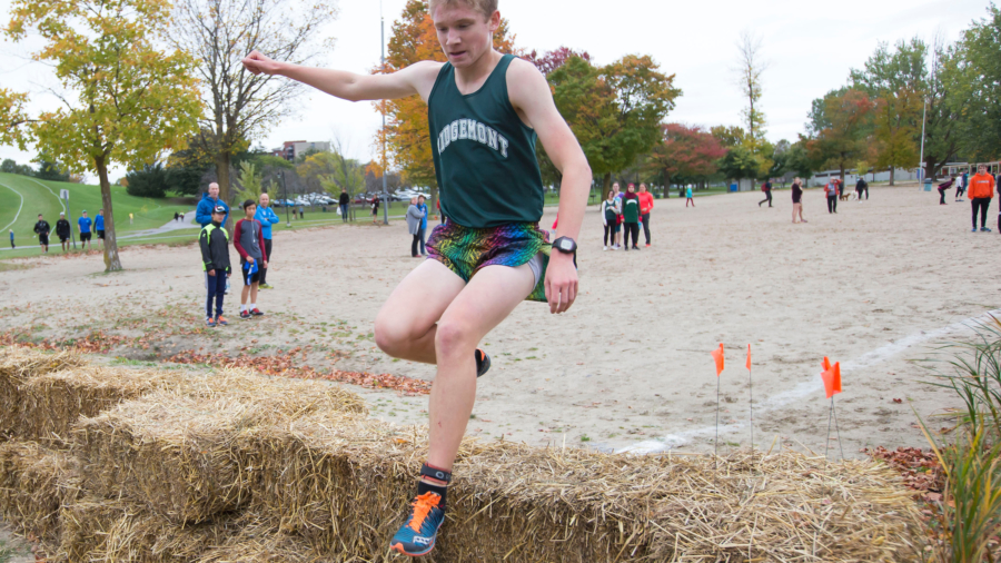 (Ottawa, Canada---13 October 2017) Joe Fast of Ridgemont High School (winner) clears the hay bales at the end of the beach during the boys Junior Varsity High School Capital Challenge Cross Country Race in Ottawa, Canada. (Photo by Sean Burges / Mundo Sport Images)