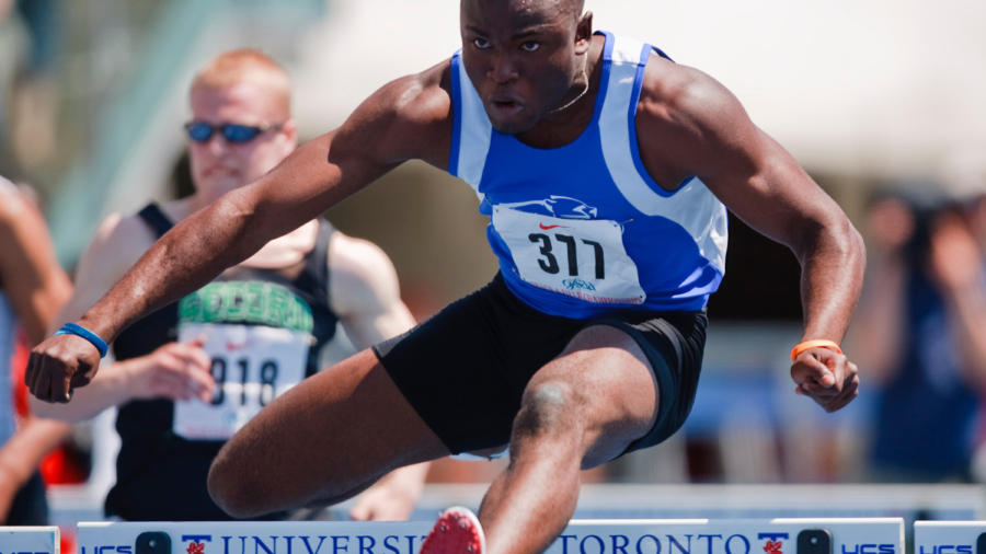 Toronto, Ontario ---05/06/09--- Segun Makinde of Colonel By Secondary School wins the senior boys 110 meter hurdles at the 2009 OFSAA Track and Field Championships at the University of Toronto, June 4, 2009..GEOFF ROBINS Mundo Sport Images