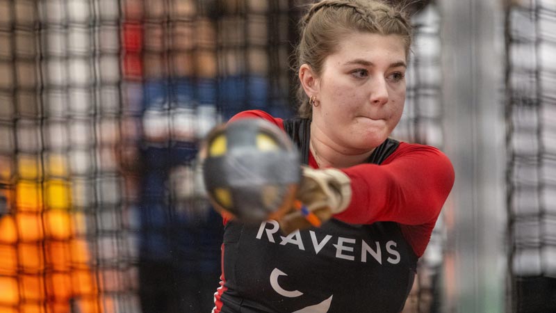 Carleton athlete competing in the weight throw